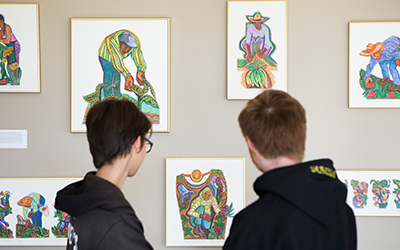 students viewing Betty LaDuke art exhibition