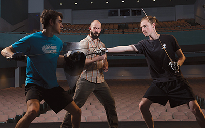 Associate Professor Jonathan Cole teaches the art of stage combat to Will Bremer ’18 (left) and William Forkin ’19.