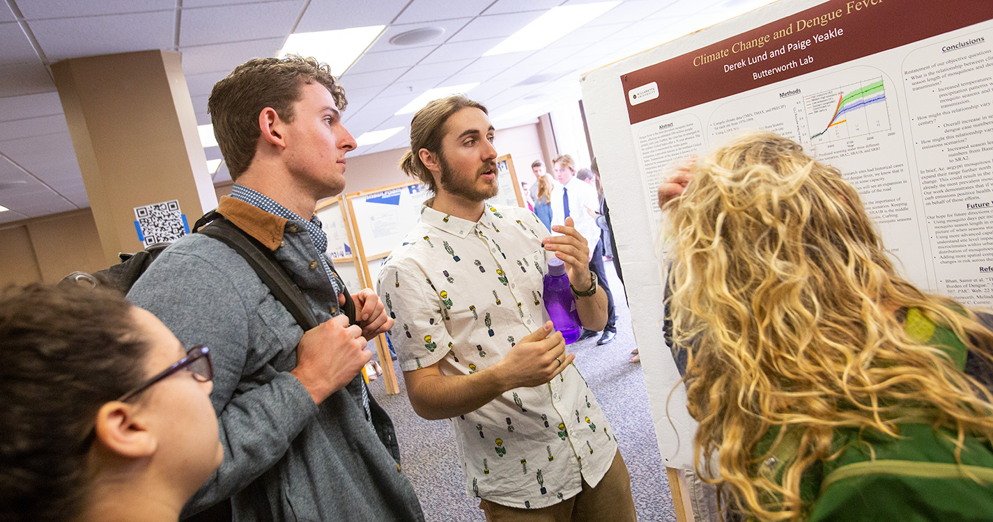 A student presents a poster at Student Scholarship Recognition Day. 