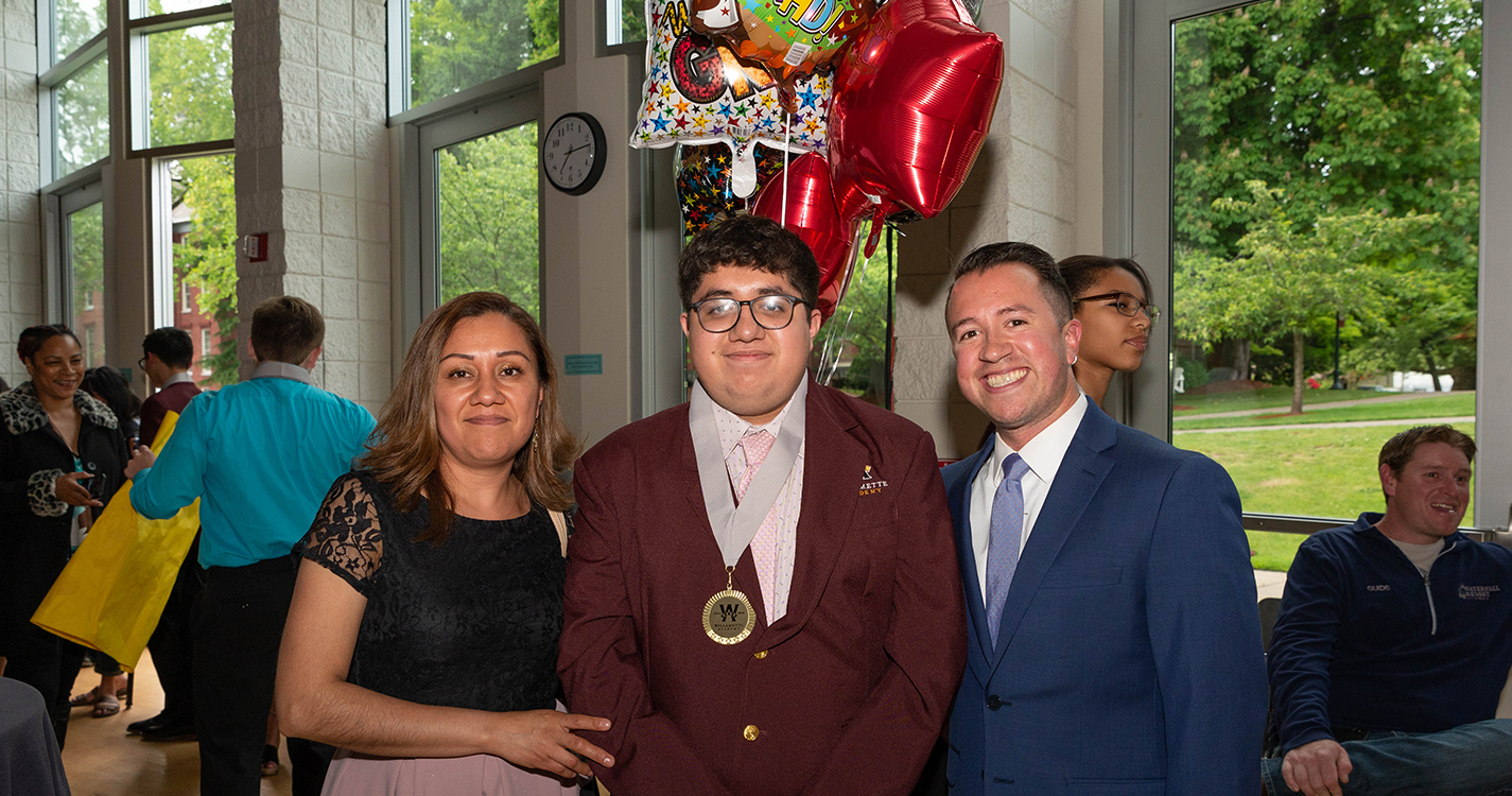 A graduate with a guest and Executive Director Emilio Solano
