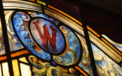 stained glass window with cardinal W