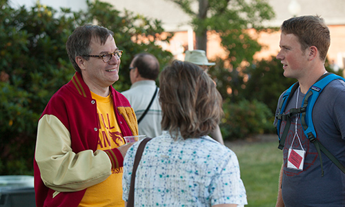 President Steve Thorsett chats with first-year students and their parents during a campus picnic.