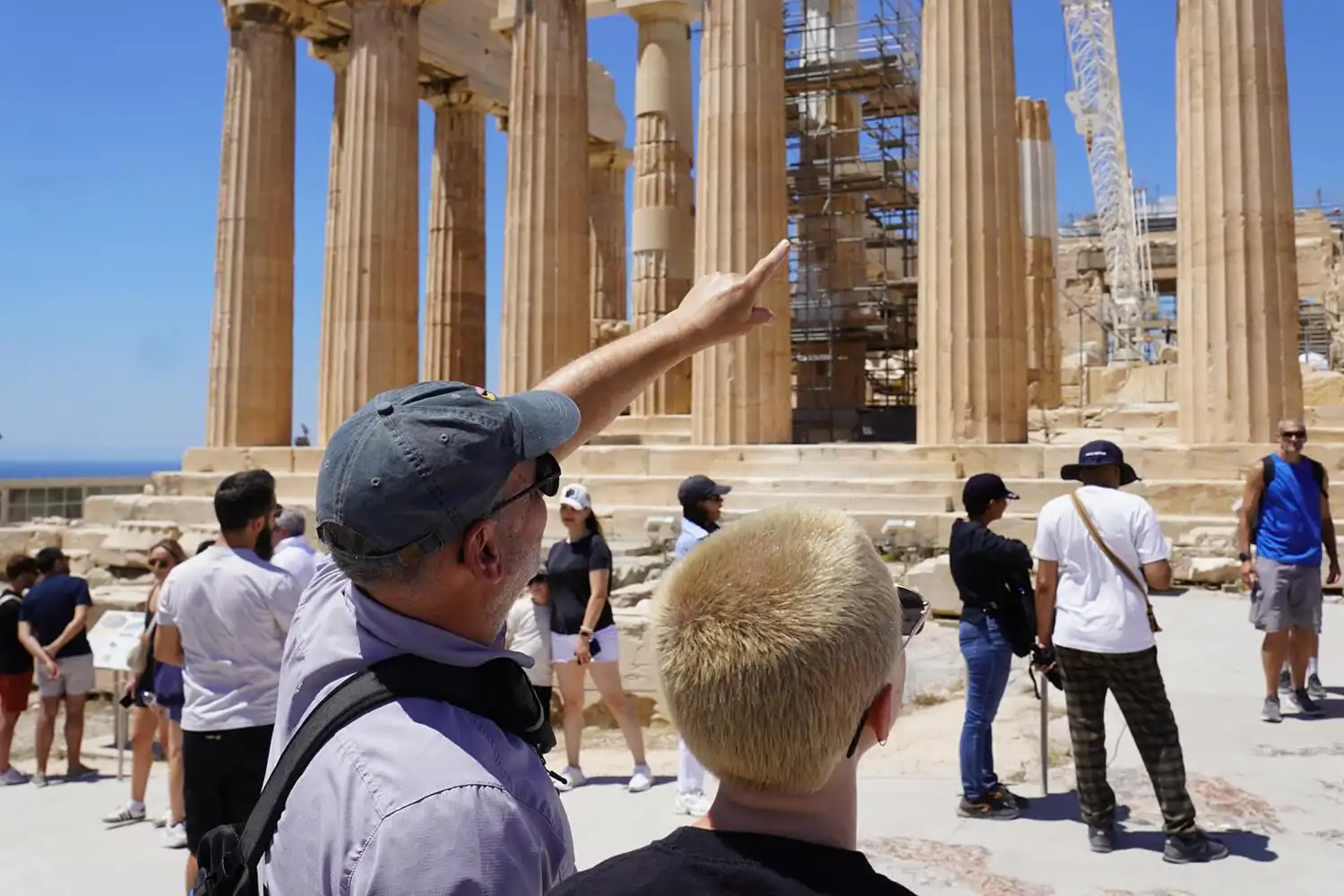 Student and a professor in front of an ancient building in greece