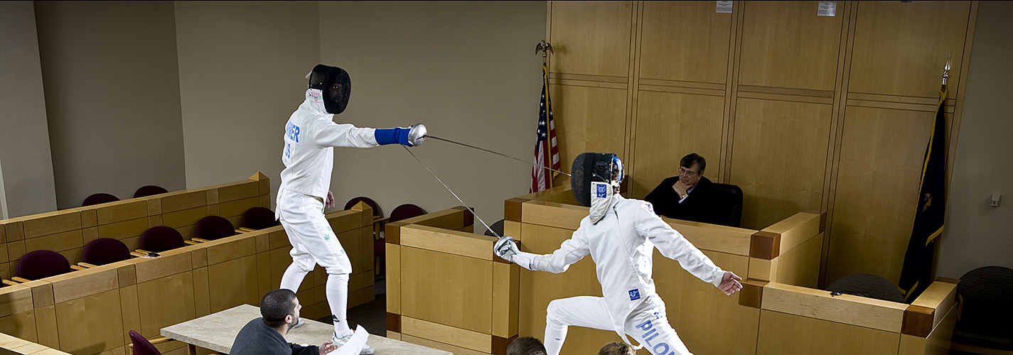 students fencing on a table