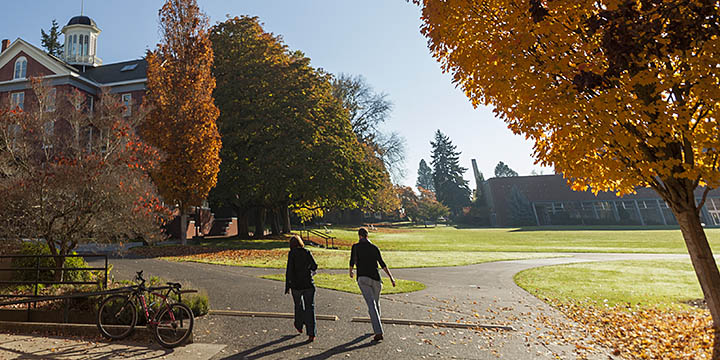Willamette students walking toward Waller Hall in autumn