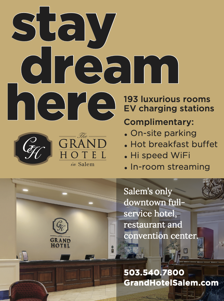 advertising the grand hotel. pictured front desk of grand hotel, "stay dream here" 