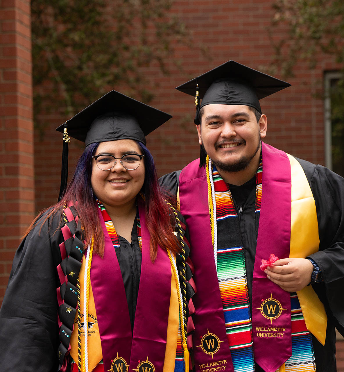 Two Willamette University students at Commencement.