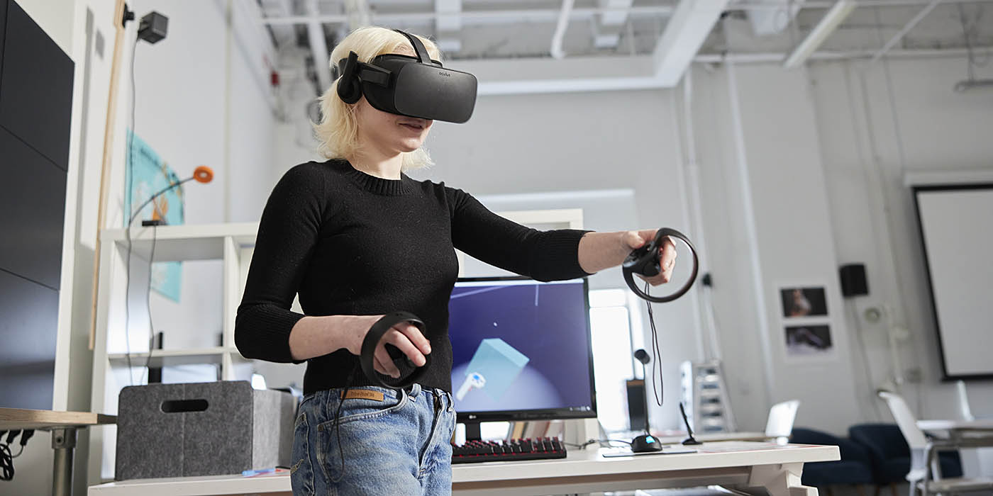 A computer science student at Willamette University using VR goggles.
