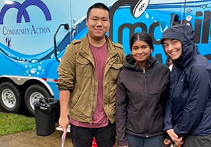 Students standing in front of a community action truck