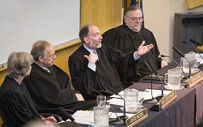Oregon Supreme Court Justice Jack Landau addresses the audience following a hearing March 3, 2017.