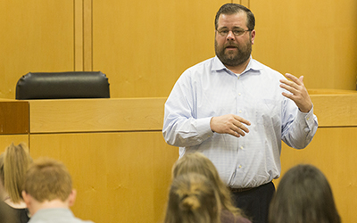 James Sullivan, a second-year law student, discusses the mock trial with Salem-area high school students who attended the Discover Law spring break program at Willamette Law.