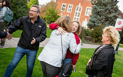 Parents greet student at Family Weekend