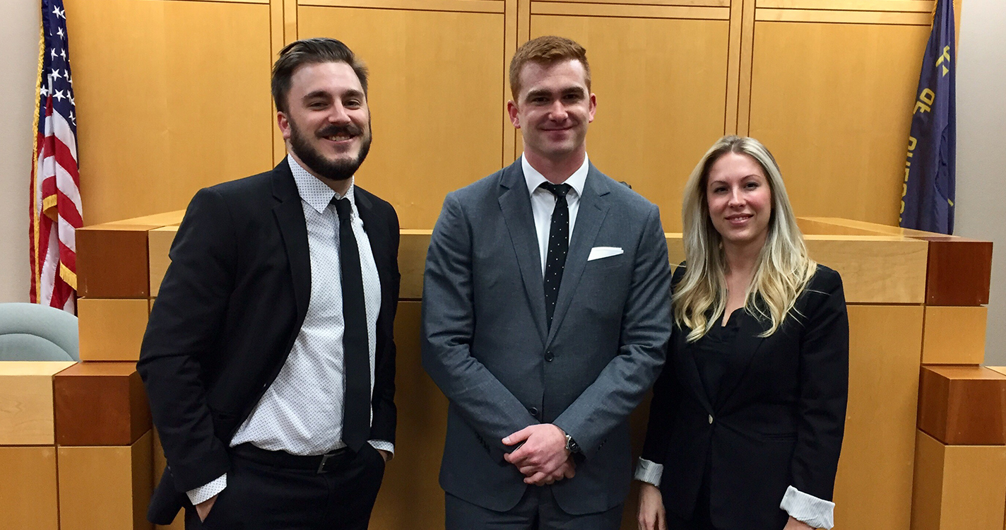 Nat Levy (L), runner-up of the Don Turner Moot Court Competition, stands next to the winners, Conor McCahill and Autumn Mills.