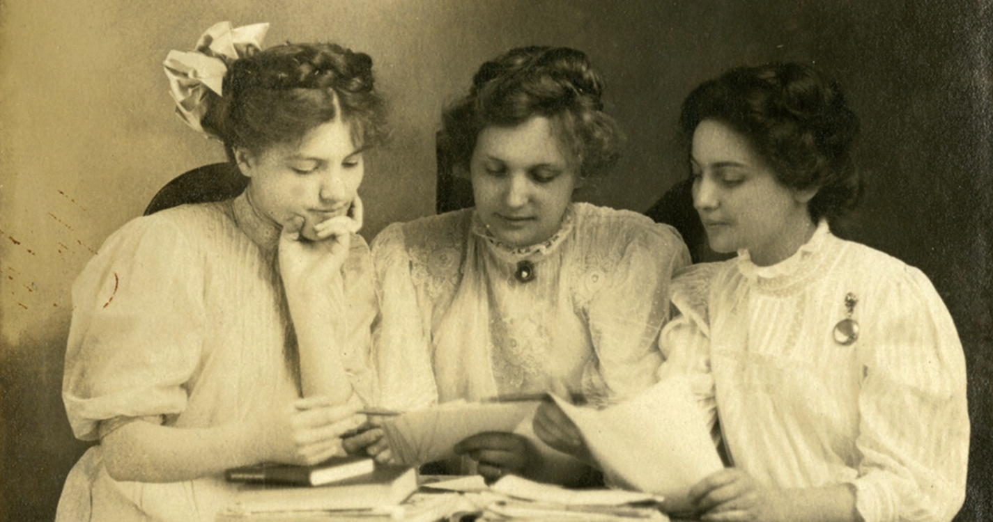 Three students prepare for a debate in 1908. 