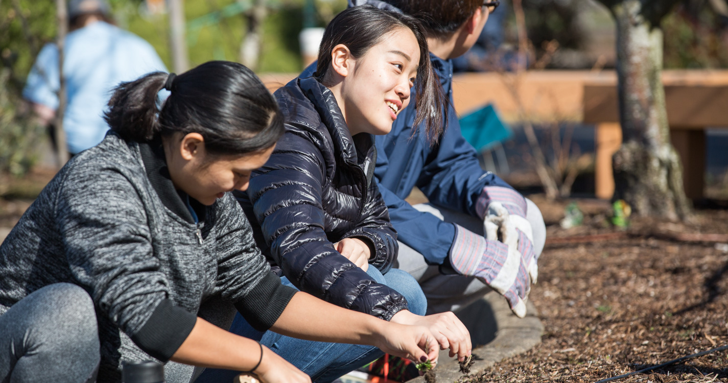 Students work the soil as part of Willamette’s Global Day of Service.