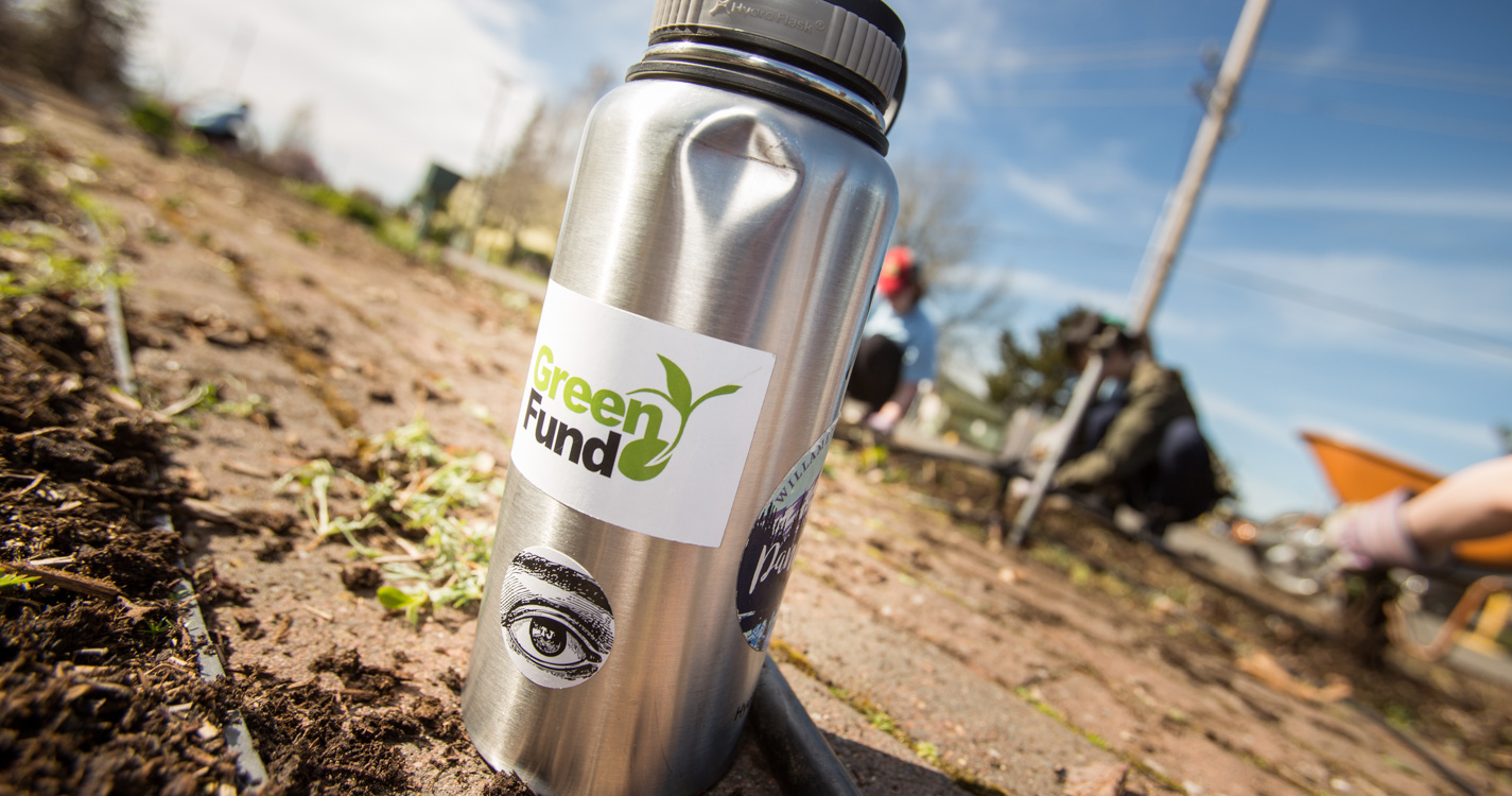 A thermos with a Green Fund sticker