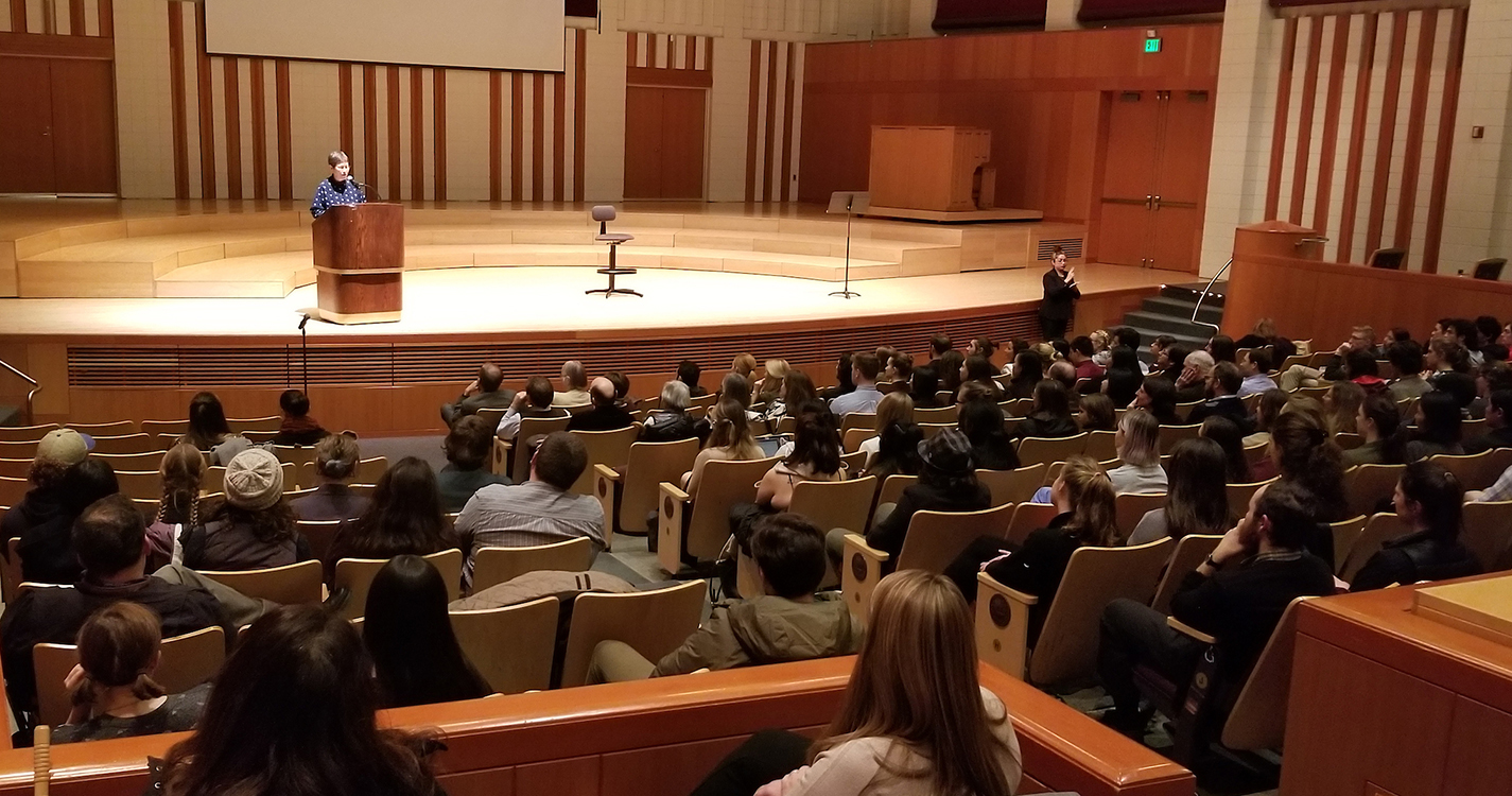 The crowd at Hudson Hall watches Anna Tsing, a professor at UC Santa Cruz, speak from a podium