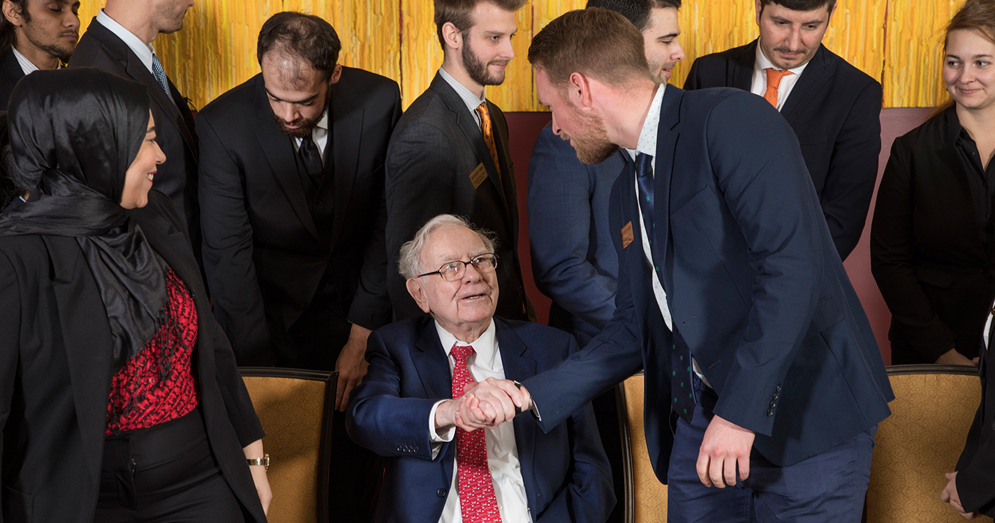 Students from Atkinson Graduate School of Management greet Warren Buffett.
