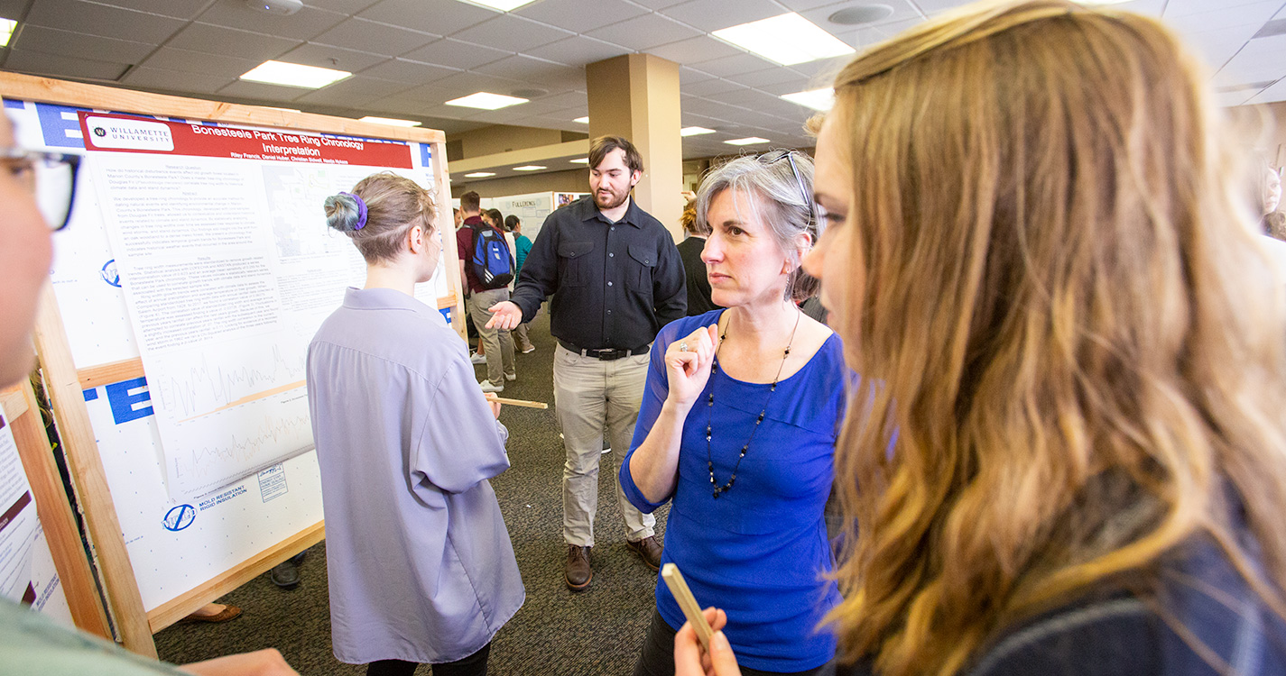 A crowd gathers around poster presentations at Student Scholarship Recognition Day. 