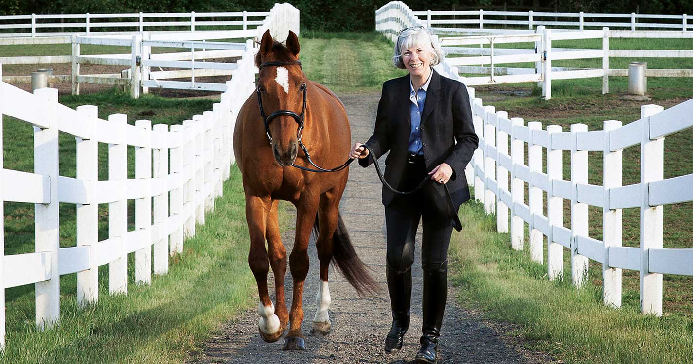 Debra Ringold, dean of Atkinson Graduate School of Management, walks with her horse Larry.