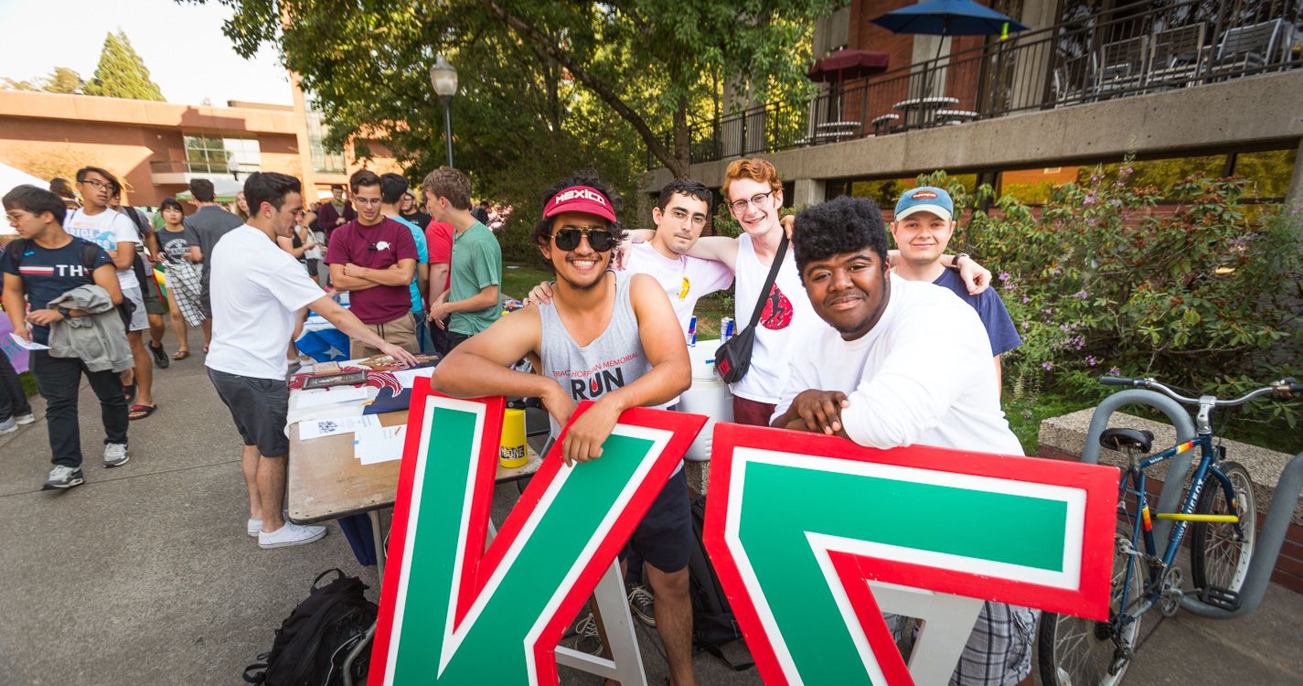 members of Kappa Sigma stand behind two large Greek letters, kappa and sigma