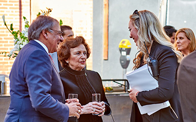 an alumna speaks with former White House Chief of Staff Leon Panetta and Sylvia Panetta, his wife