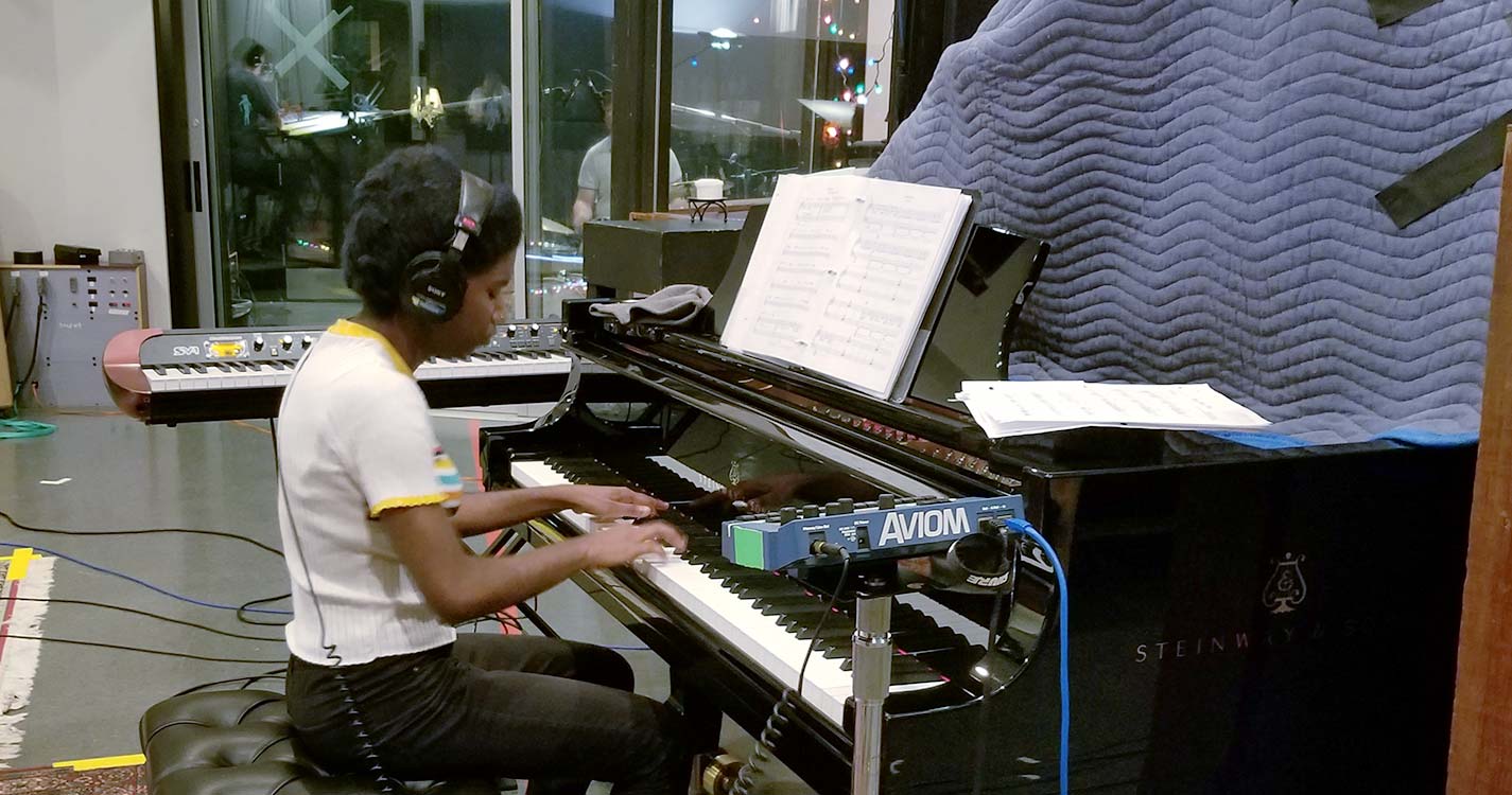 Student is recorded playing a piano. 
