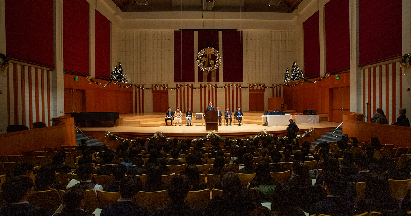 TIUA President Hiroshi Takahashi speaks before a crowd in Hudson Hall