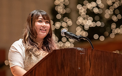 Mai Hiwatashi speaks at podium