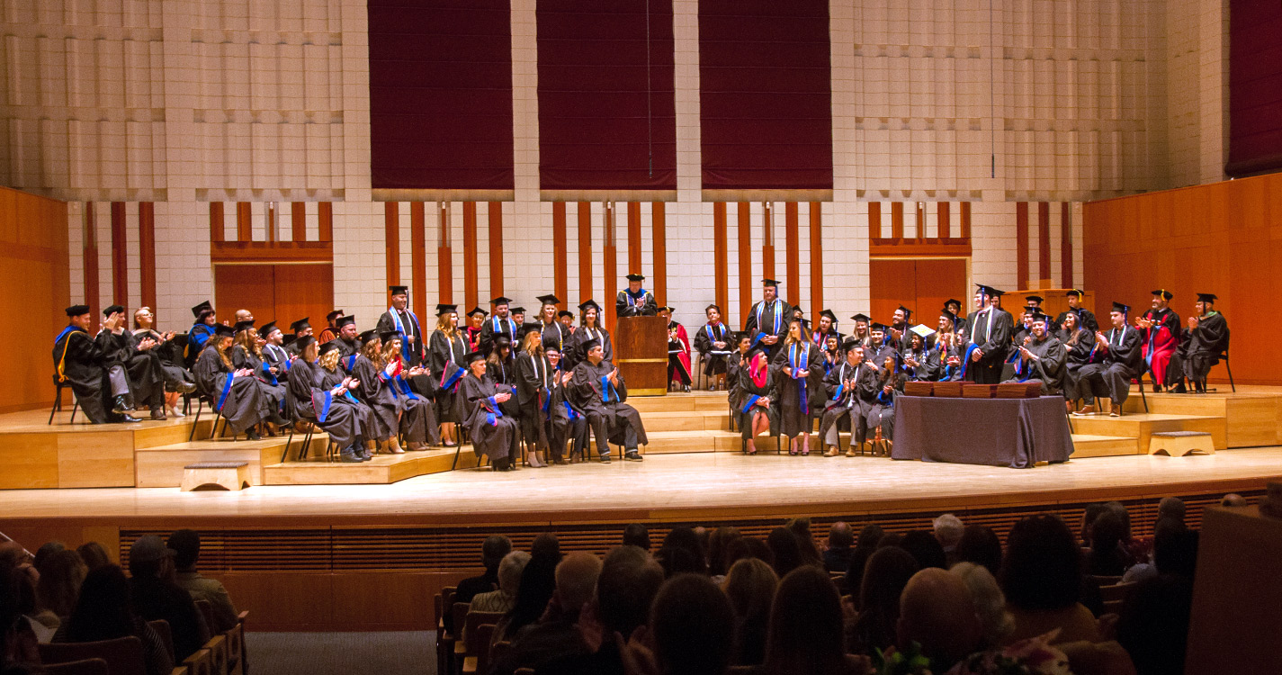 Stage in Hudson Hall with graduating class seated