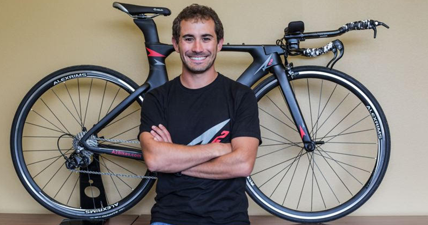AJ Alley stands with his original carbon fiber Speed Phreak bicycle 