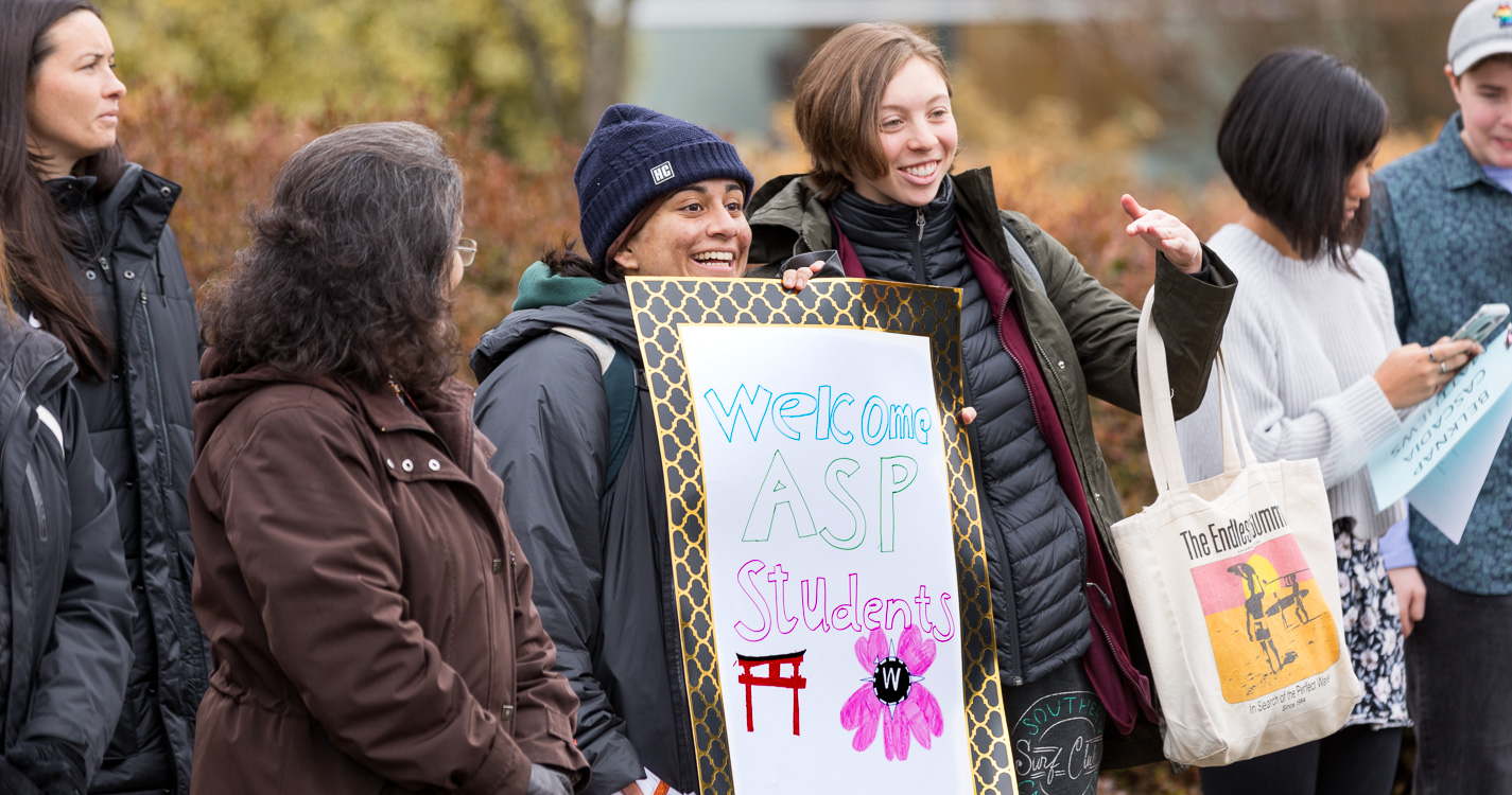 Willamette community members holding welcome signs
