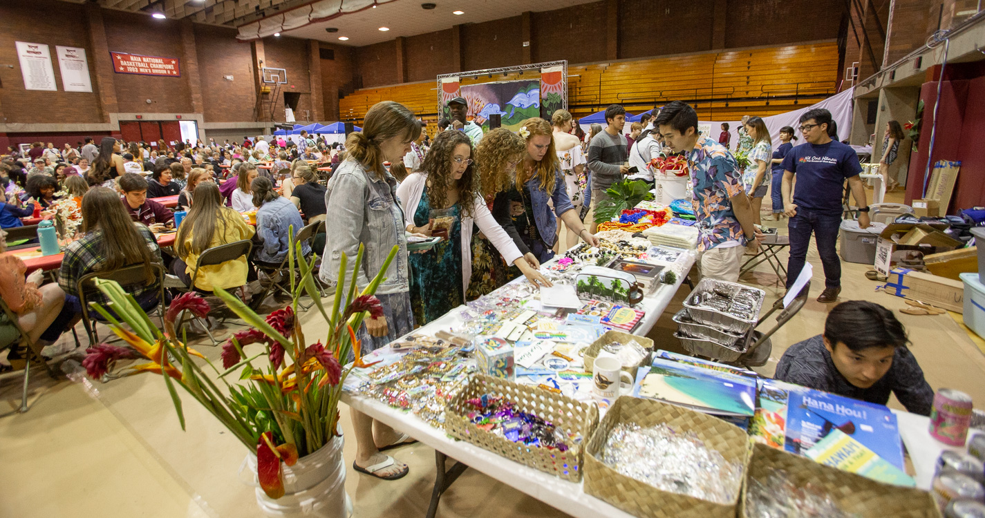visitors look at merchandise at the event's store