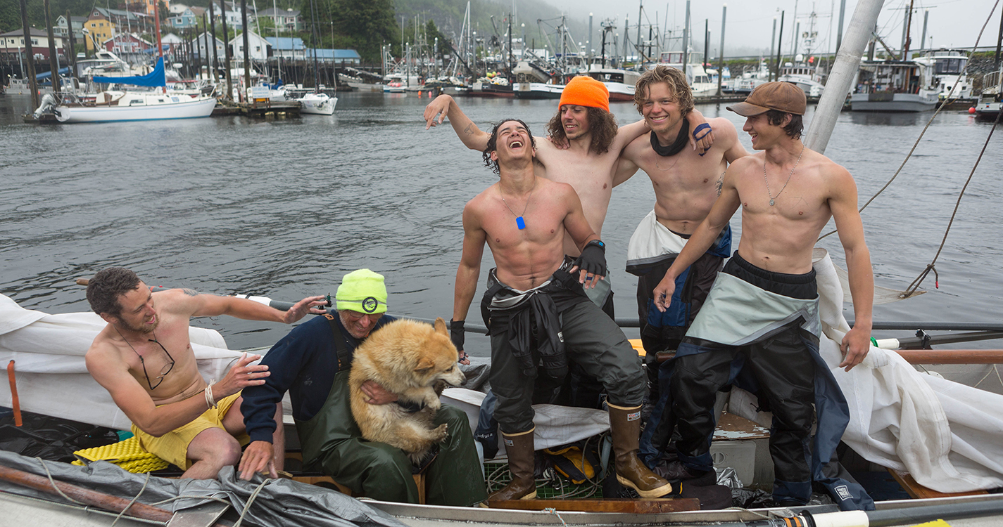 Student's sailing team celebrates at the finishing line by posing for a photo in Ketchikan. 