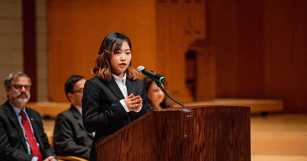 ASWU ASP representative, Akina Kobayashi addresses the 31st ASP class from a podium.
