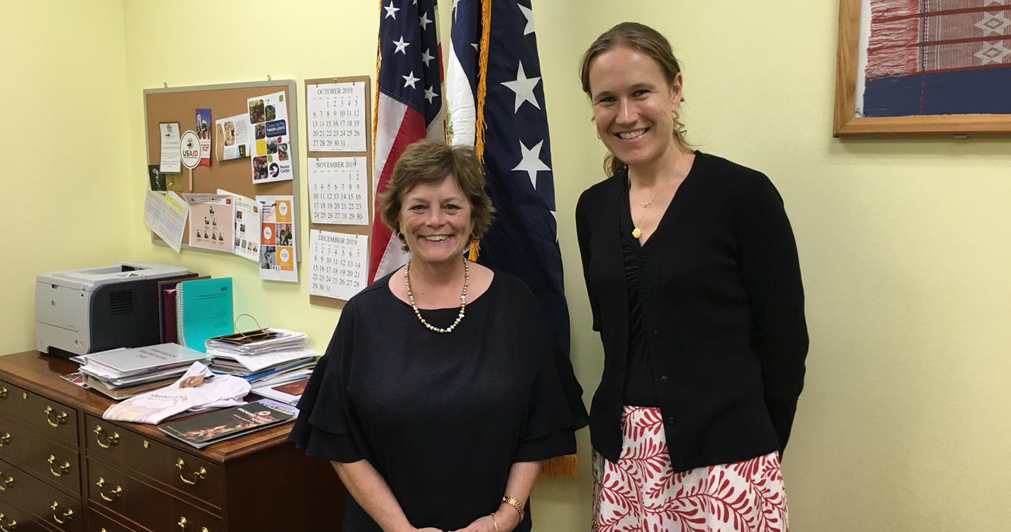 Kimberly Cole ’02 stands next to the U.S. Ambassador