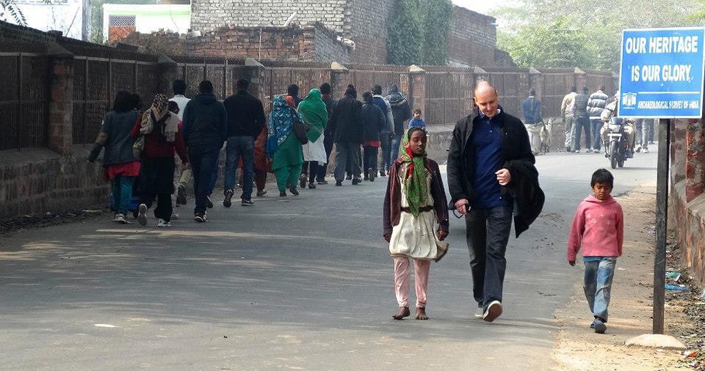 Swinn walks with two children in the town of Fatehpur Sikri. 