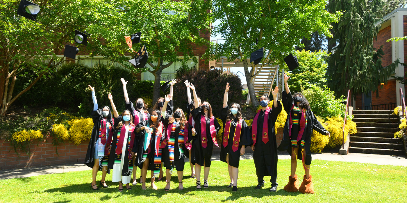 Sociology graduates toss their caps into the air