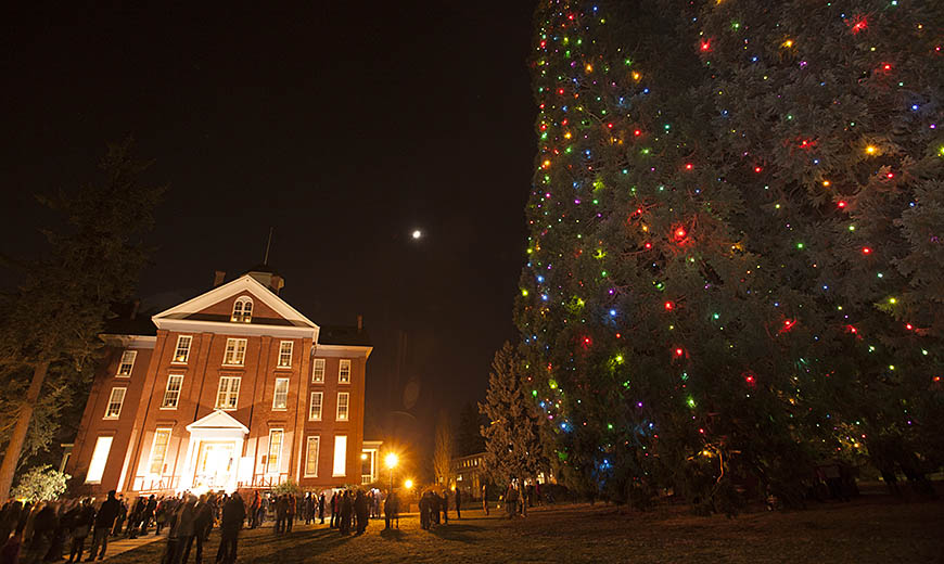 A group of people attend Willamette's Star Trees lighting next to Waller Hall on the Salem Campus
