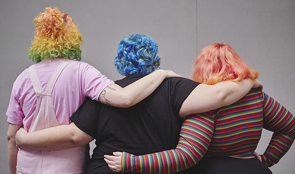 Three students with rainbow colored hair. 