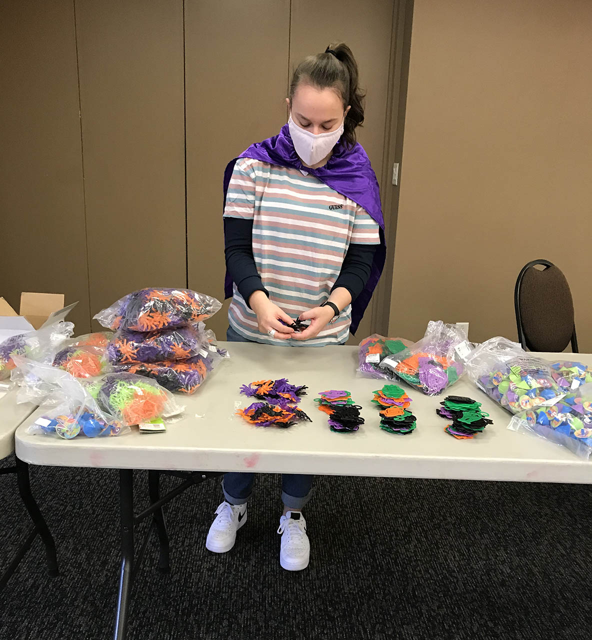 Student volunteering with making supply bags