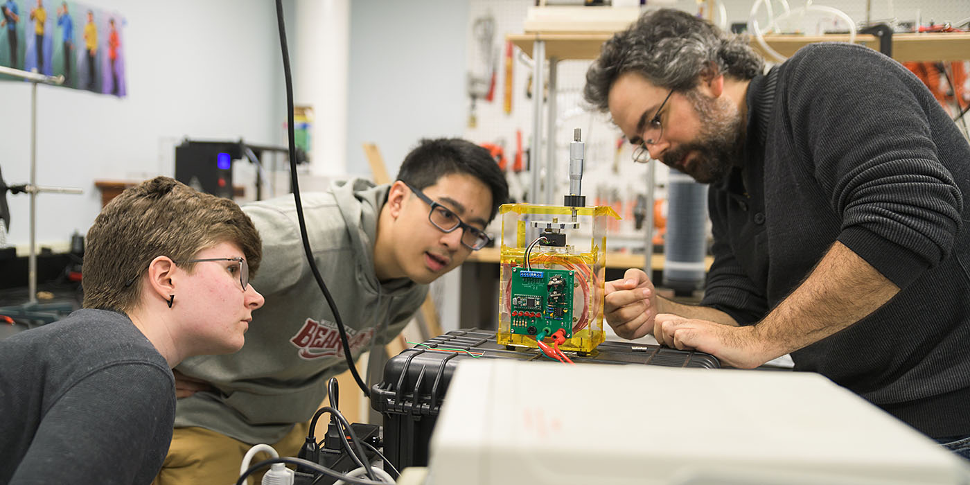 Willamette physics students and professor in a lab